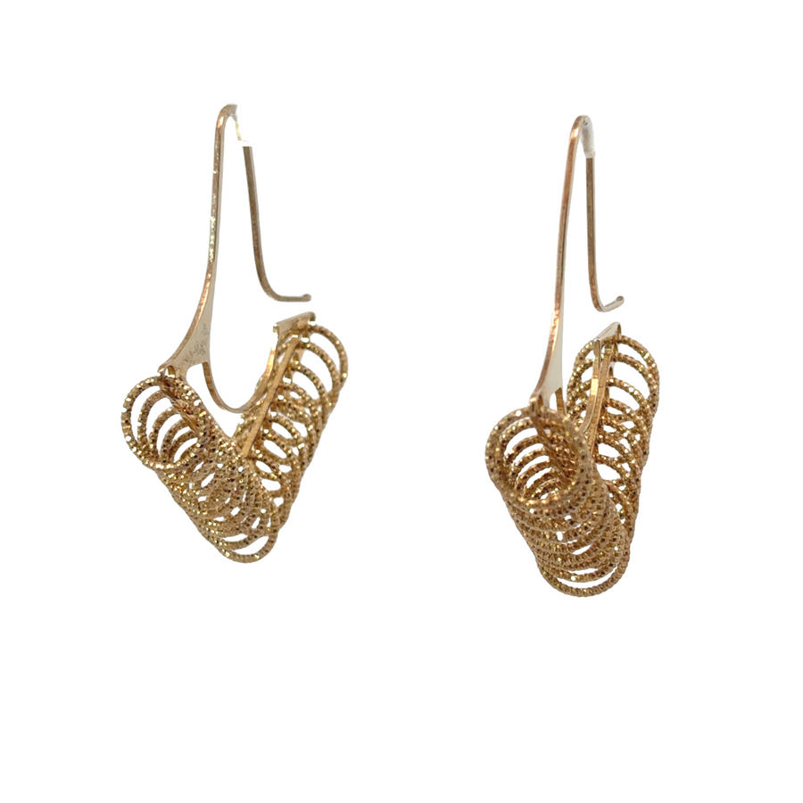 Close-up of minimalist silver earrings with small circles