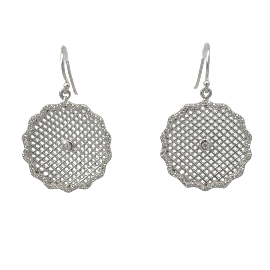 Close-up of bold silver large circle earrings on white background