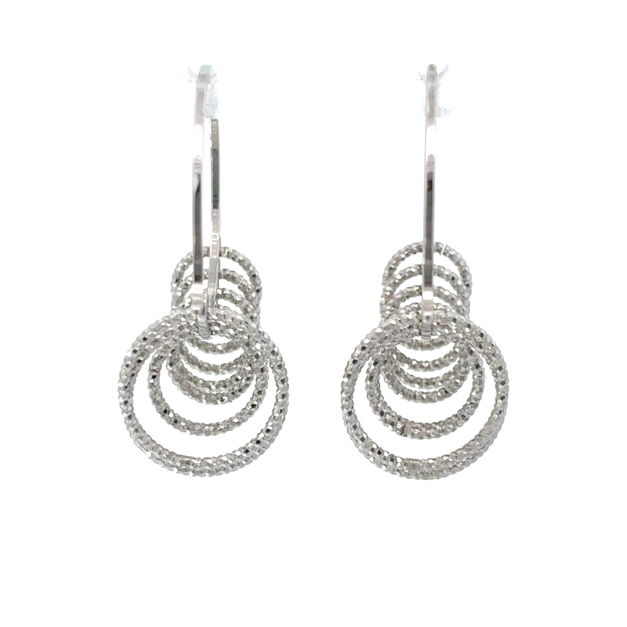 Pair of diamond cut silver stud earrings displayed on black velvet