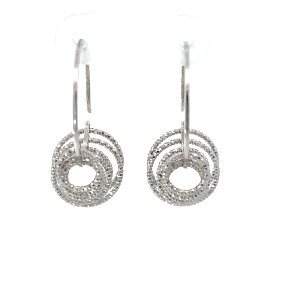 Small diamond cut silver earrings on white background