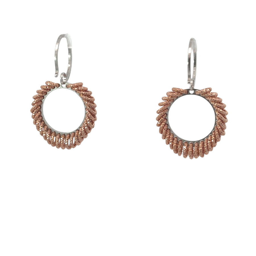 Pair of small silver drop earrings displayed on jewelry holder