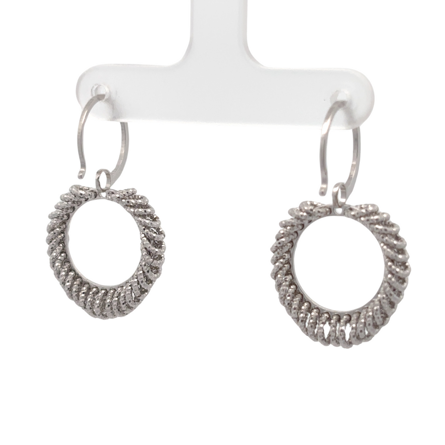 Woman wearing small silver earrings with casual outfit