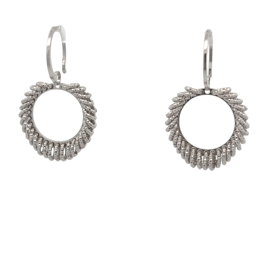 Close-up of polished small silver earrings on white background
