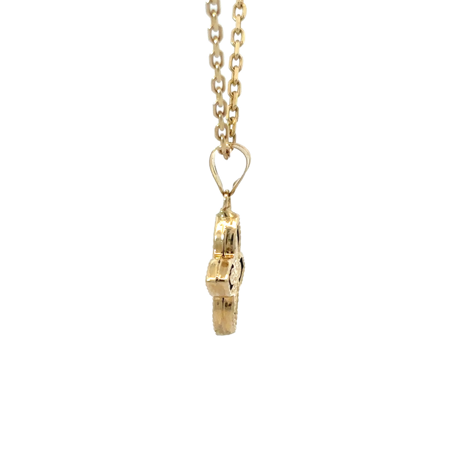 Close-up of unisex gold pendant with vibrant blue centerpiece