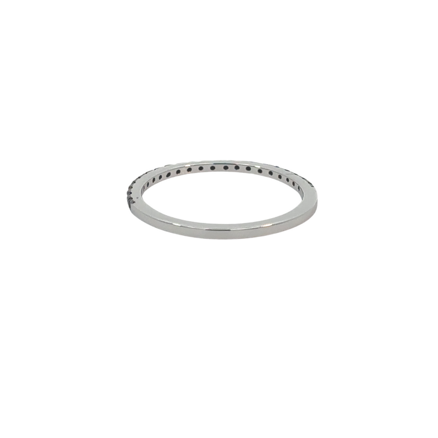 Woman wearing elegant thin black silver ring on finger