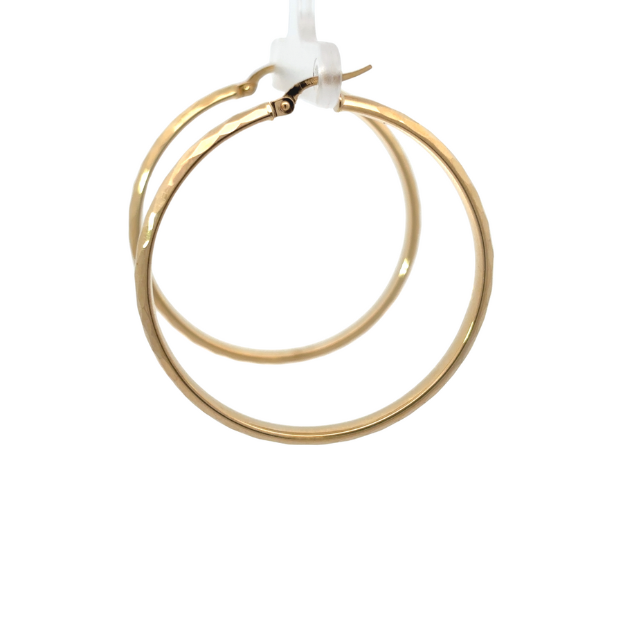 Woman wearing timeless 14k gold earrings with a smile