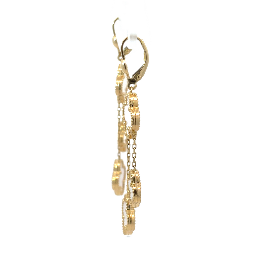 Pair of minimalist 14k gold earrings on neutral fabric