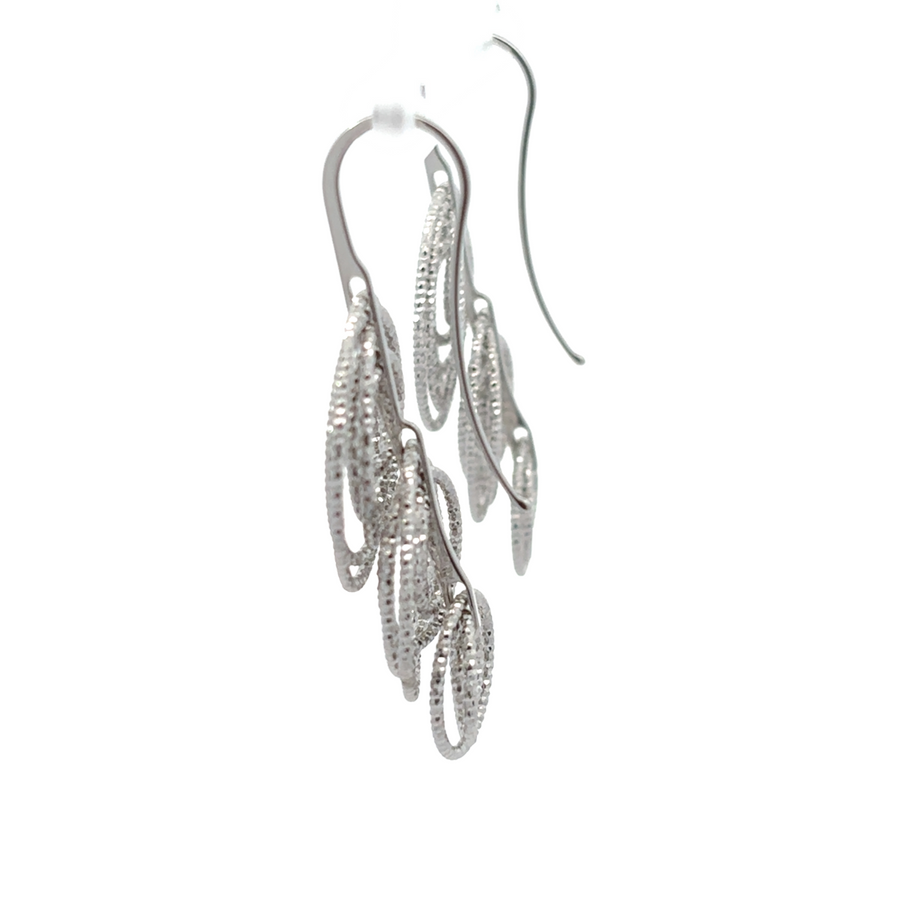 Close-up of sparkling diamond-cut silver earrings for women