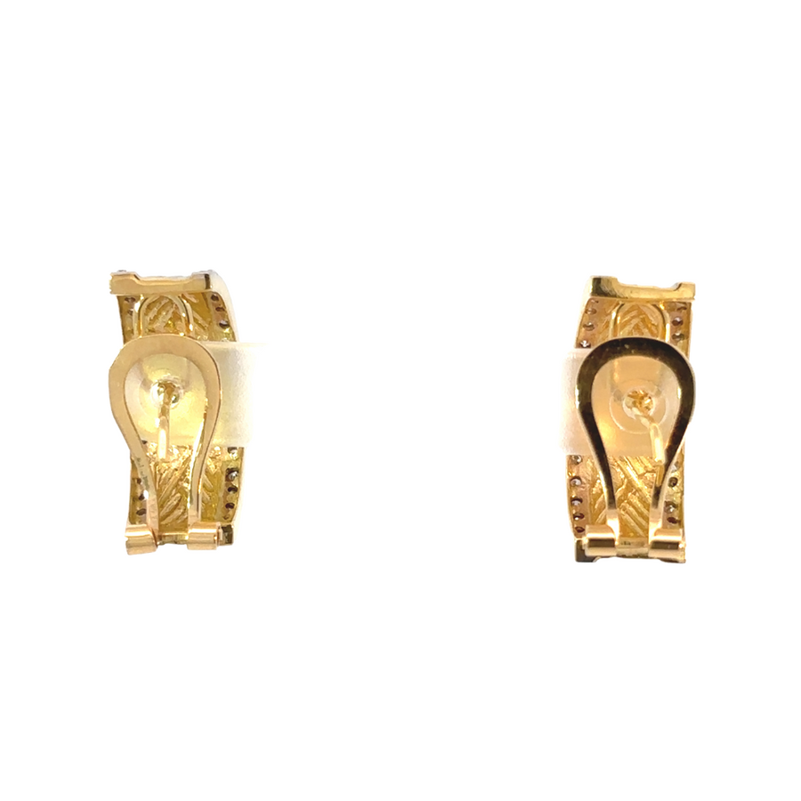 Woman wearing elegant two-tone diamond earrings in natural light
