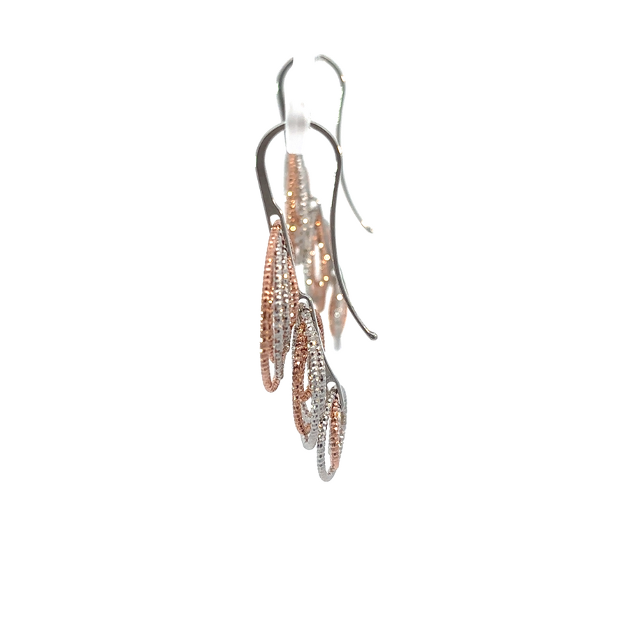 Close-up of diamond-cut texture on two-tone silver earrings