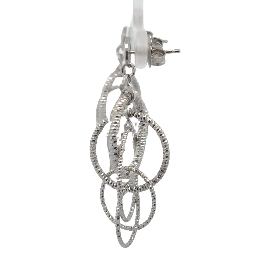 Close-up of two-toned silver earrings highlighting contrasting tones