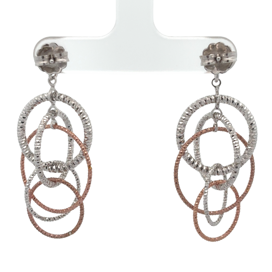 Side view of two-toned silver earrings showing design details