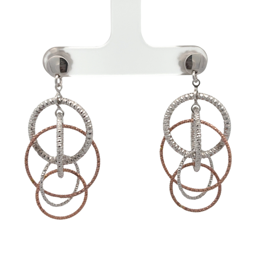 Pair of two-toned silver earrings resting in jewelry box

