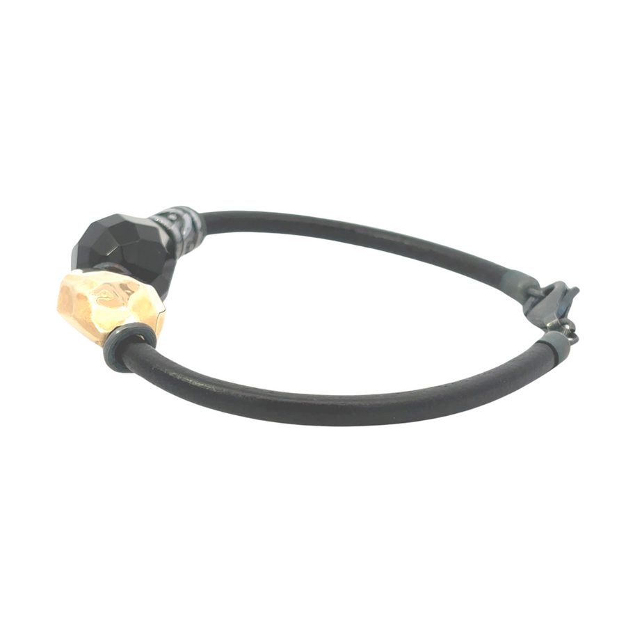 Black leather necklace with matching bracelet on white background