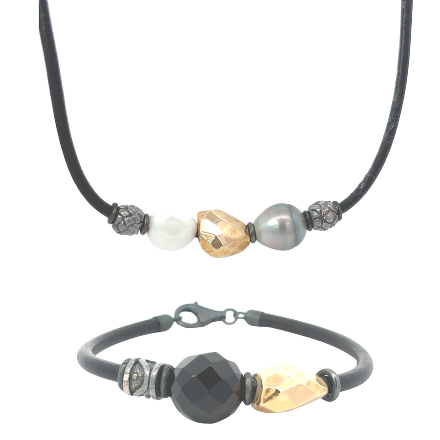 Unisex leather necklace and bracelet set displayed flat