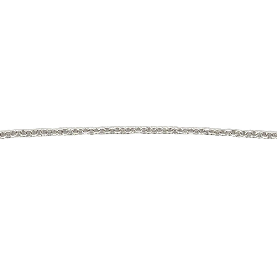 Close-up of sparkling white CZ stone on silver necklace