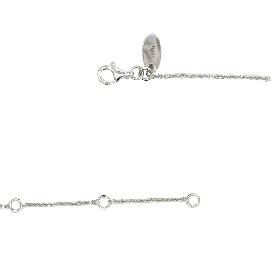 Woman wearing adjustable silver necklace with white CZ charm