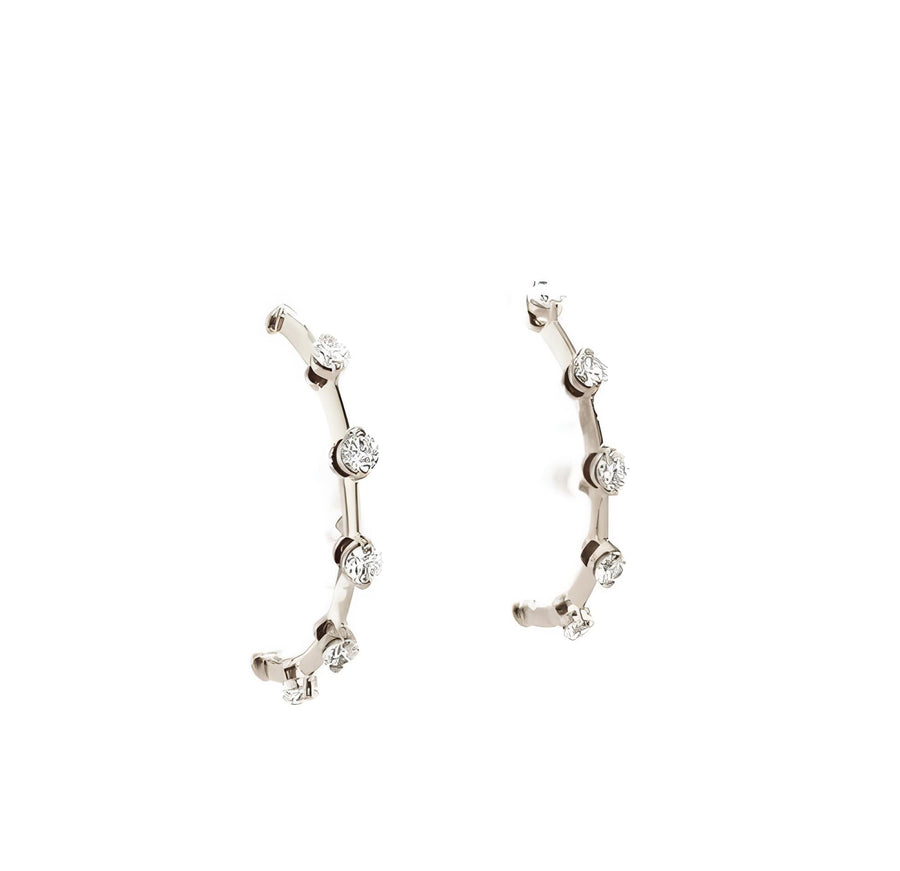 Close-up of white gold earrings with sparkling diamond accents