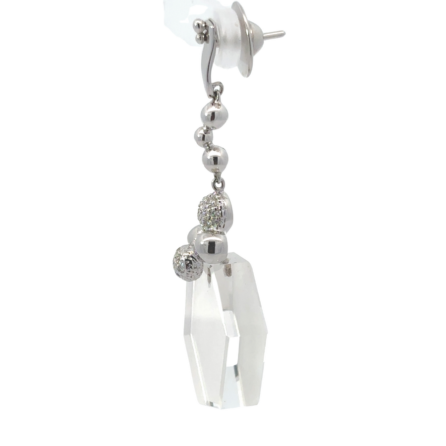 Close-up of 18k white gold earrings featuring diamond accents