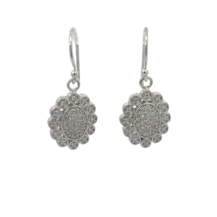 White gold silver flower earrings on a neutral background