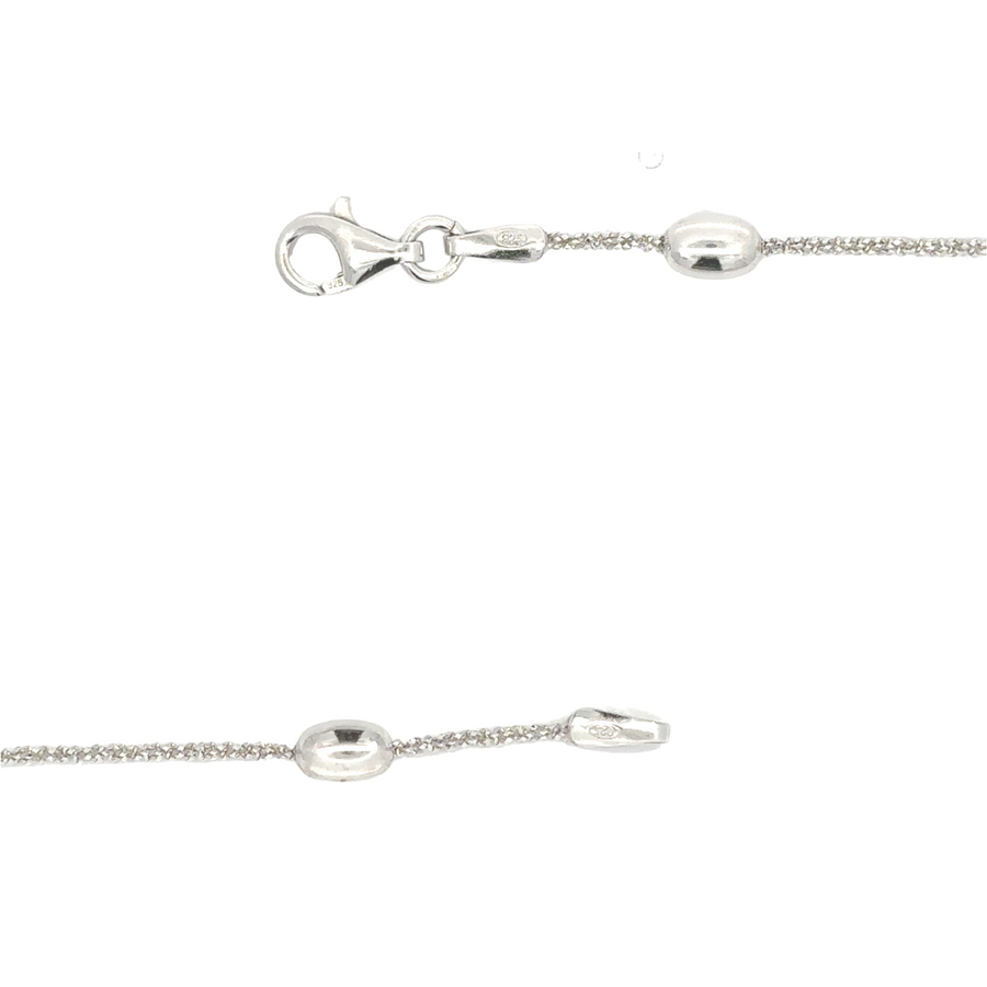 Close-up of polished silver chain necklace