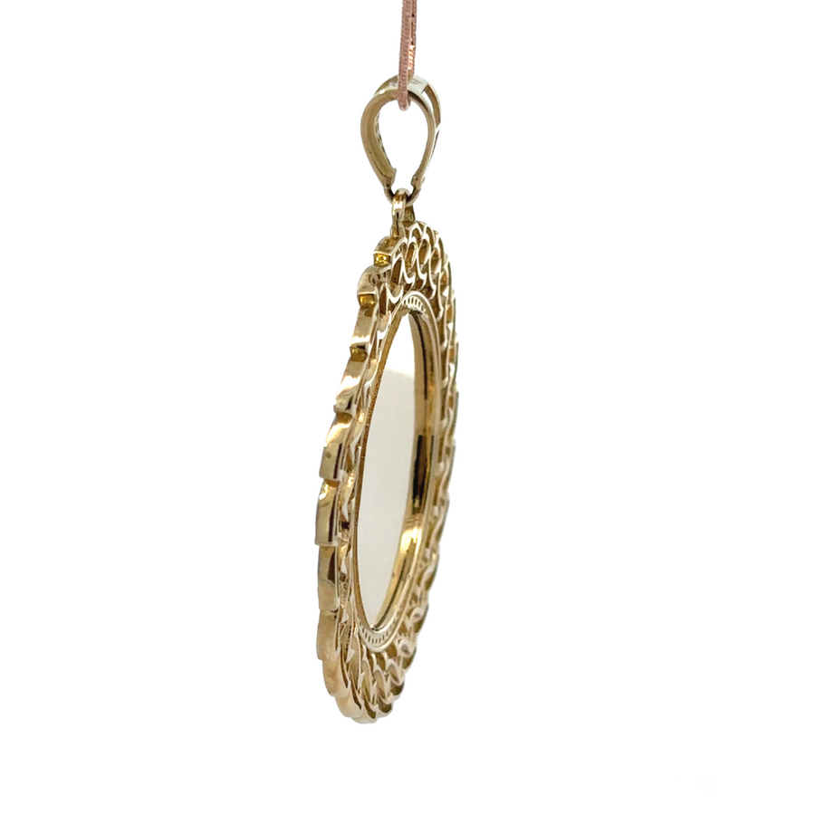 Model wearing XL gold pendant with red accent, styled casually