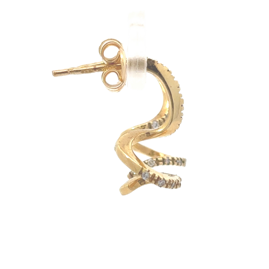 Close-up of diamond-studded yellow gold earrings