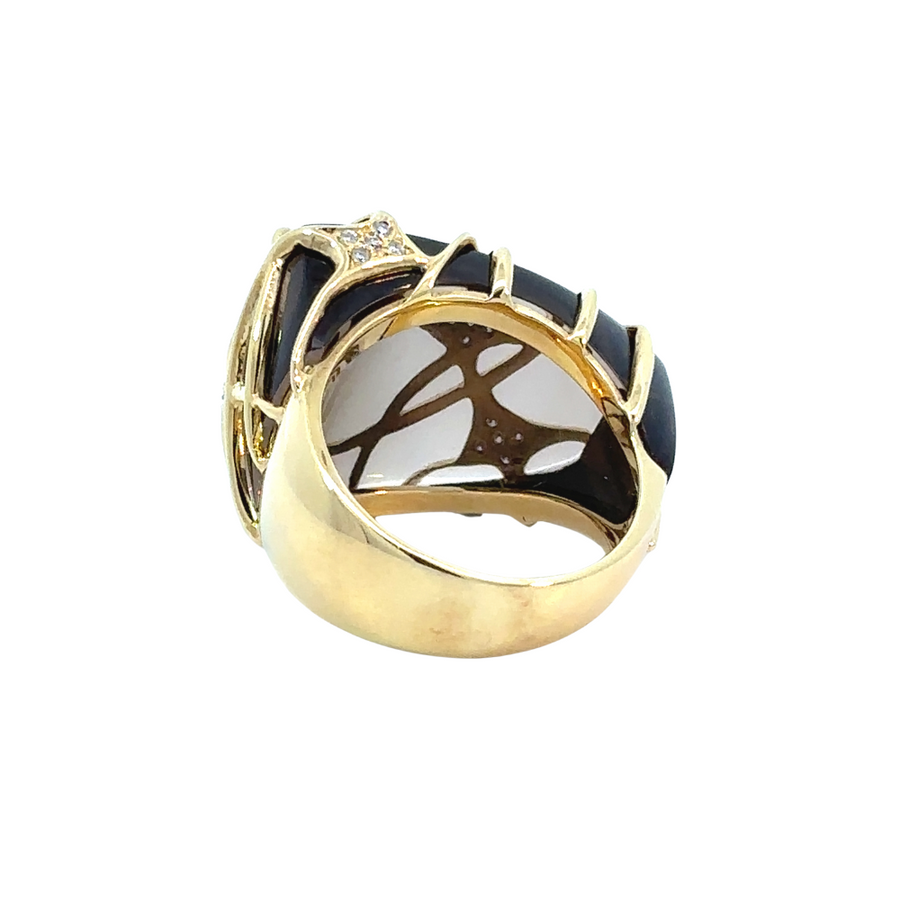Hand wearing 18k gold ring with smoky quartz and diamonds