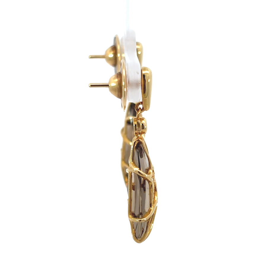 Elegant yellow gold earrings with smoky quartz stones on white marble background