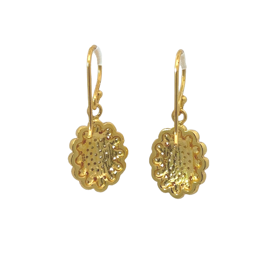 Close-up of delicate flower design in gold-plated earrings