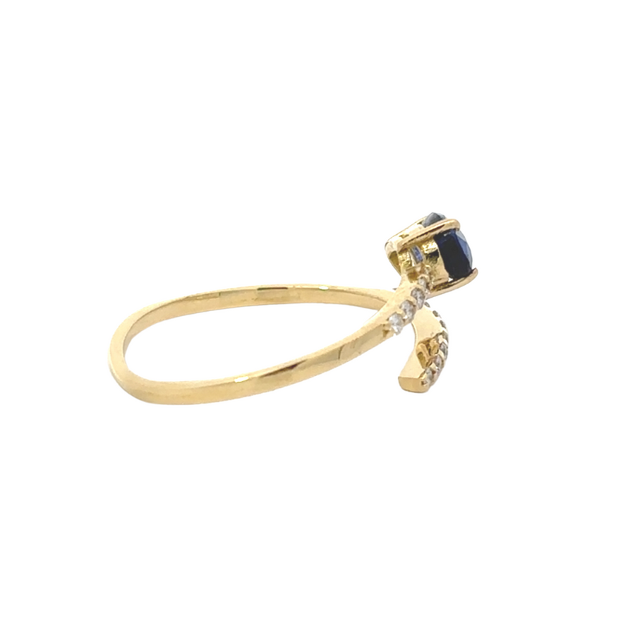 Close-up of open design gold ring with sapphire
