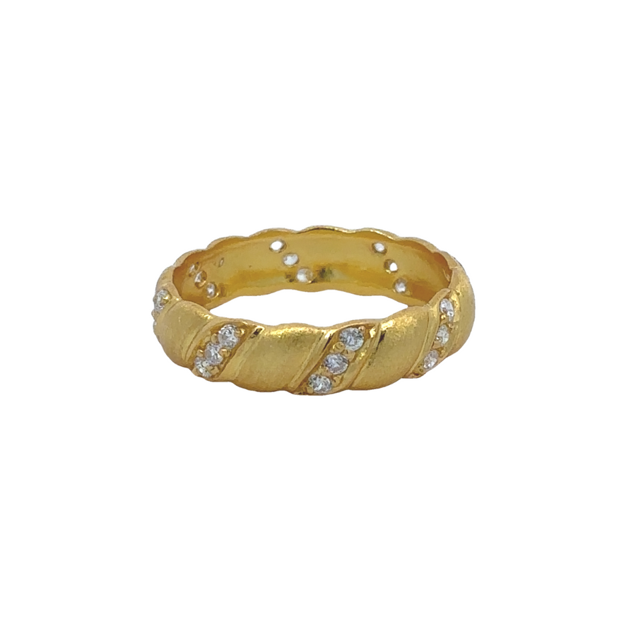 Close-up of yellow gold ring with CZ and scratch design